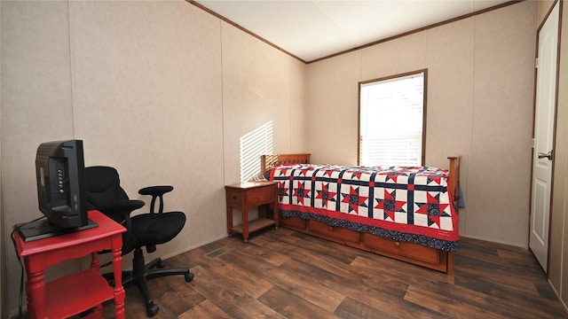 bedroom featuring ornamental molding and dark hardwood / wood-style floors