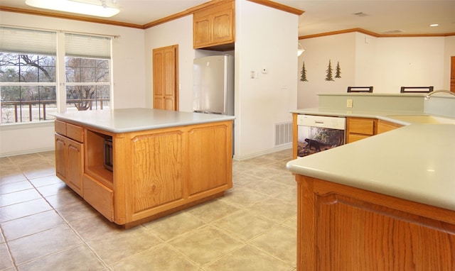 kitchen with a kitchen island, stainless steel refrigerator, sink, white dishwasher, and crown molding