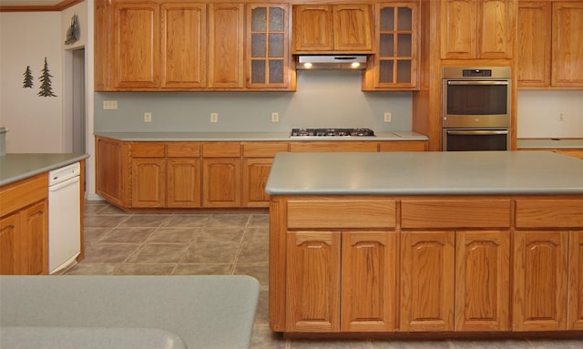 kitchen featuring crown molding, appliances with stainless steel finishes, and a center island