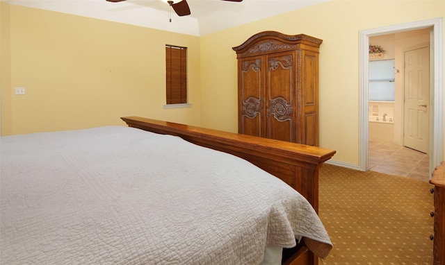 tiled bedroom with ceiling fan and connected bathroom