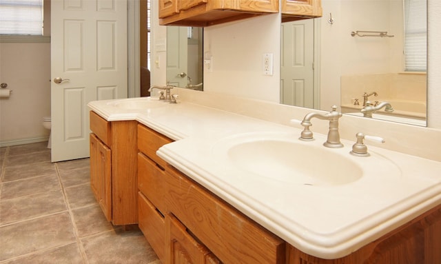 bathroom featuring vanity, toilet, and tile patterned flooring