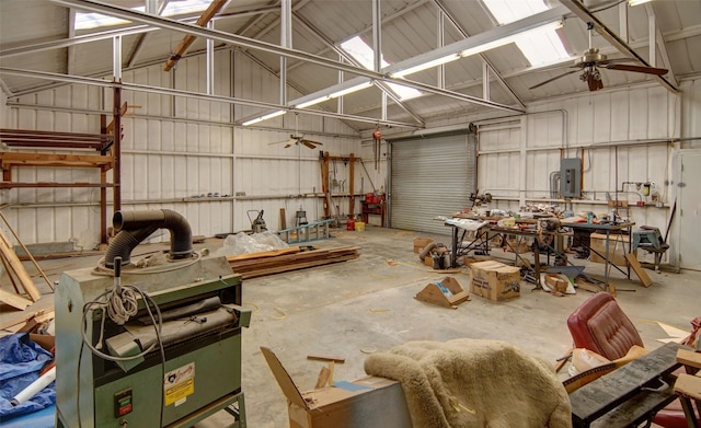 garage with ceiling fan, electric panel, and a workshop area