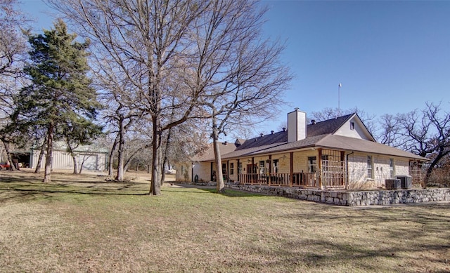 view of yard featuring central AC and a porch