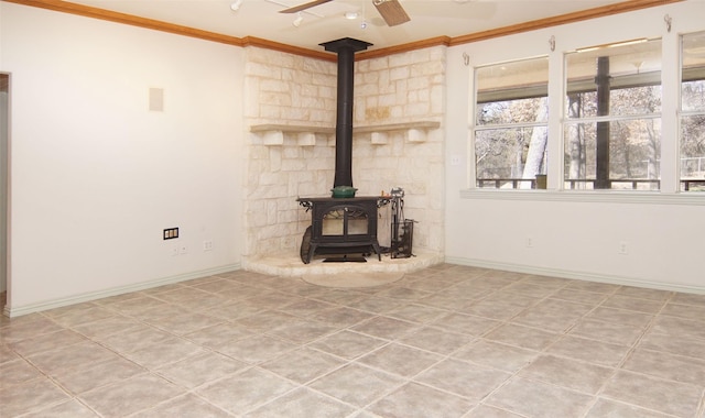 unfurnished living room featuring crown molding, ceiling fan, and a wood stove