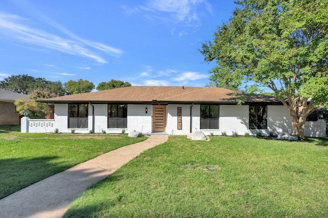 ranch-style home featuring a front yard