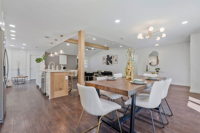 dining room featuring a chandelier, vaulted ceiling with beams, sink, and dark hardwood / wood-style flooring