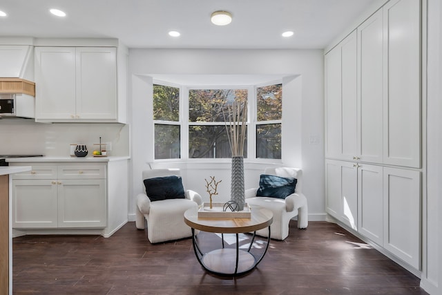 sitting room with dark hardwood / wood-style flooring