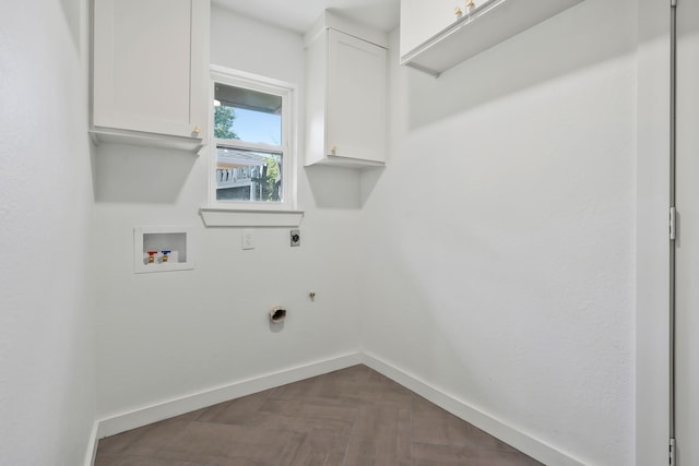 laundry area with parquet floors, cabinets, washer hookup, and hookup for an electric dryer