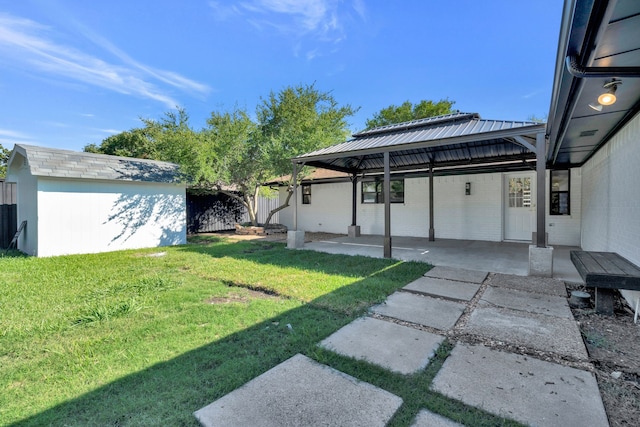 view of yard with a gazebo, a patio area, and a storage unit