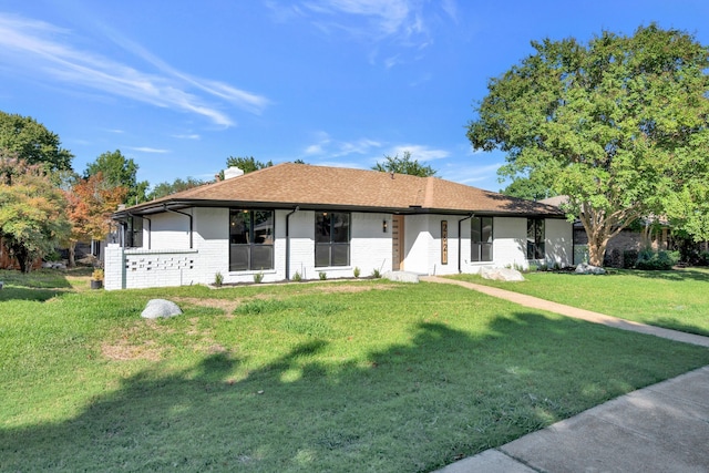 ranch-style home with a front lawn