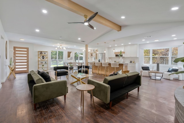 living room with vaulted ceiling with beams, ceiling fan with notable chandelier, a wealth of natural light, and dark hardwood / wood-style floors