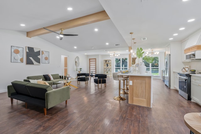 living room with dark wood-type flooring, ceiling fan with notable chandelier, and vaulted ceiling with beams