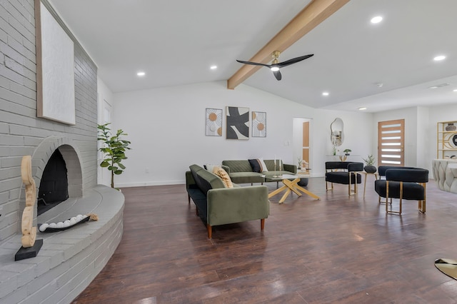 living room with ceiling fan, vaulted ceiling with beams, dark wood-type flooring, and a fireplace