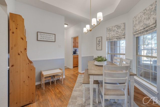 dining area featuring a chandelier and light hardwood / wood-style flooring