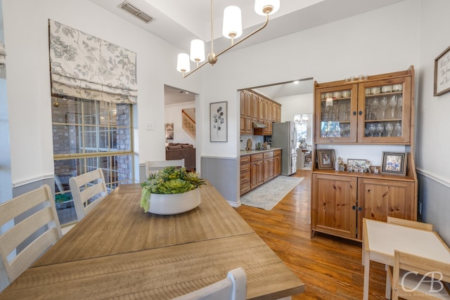 dining space with an inviting chandelier, dark hardwood / wood-style flooring, and sink