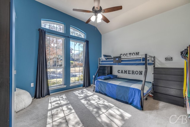 bedroom featuring ceiling fan, lofted ceiling, light carpet, and multiple windows