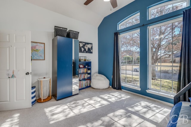 bedroom with vaulted ceiling, light colored carpet, and ceiling fan