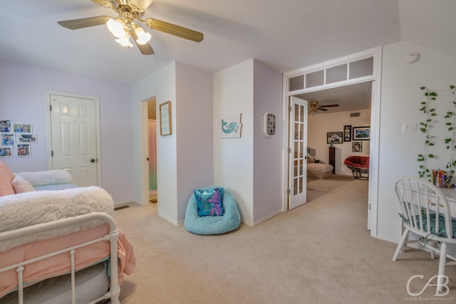 carpeted bedroom with french doors and ceiling fan