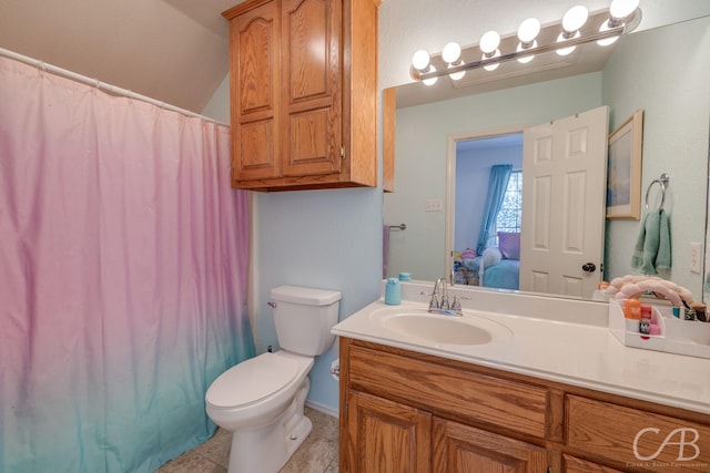 bathroom with vanity, lofted ceiling, toilet, and walk in shower