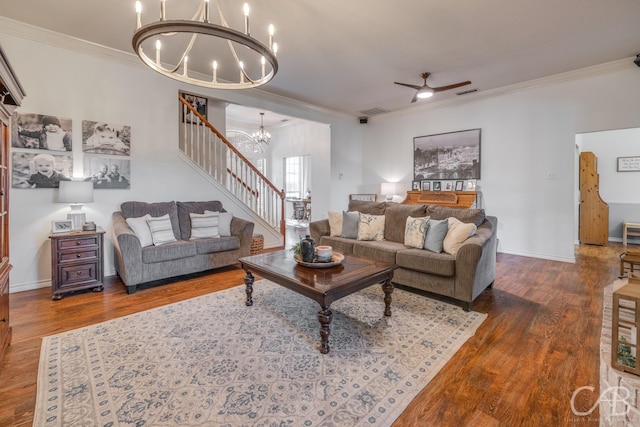 living room featuring ornamental molding, ceiling fan with notable chandelier, and dark hardwood / wood-style flooring