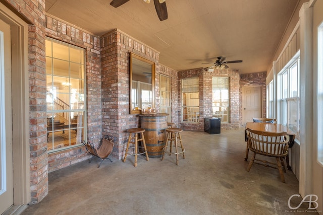 view of patio / terrace featuring ceiling fan and a bar