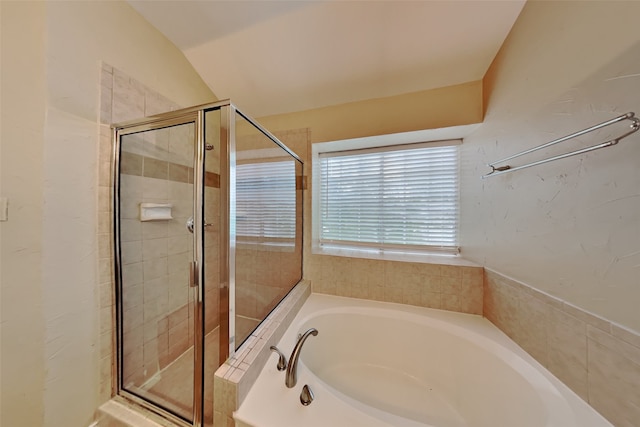 bathroom with lofted ceiling and separate shower and tub