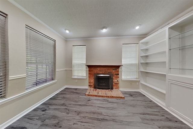 unfurnished living room with crown molding, wood-type flooring, a fireplace, and a textured ceiling