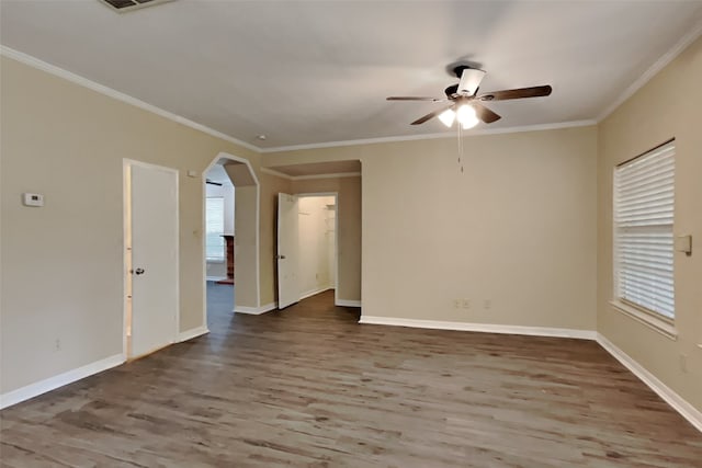 empty room with ornamental molding, hardwood / wood-style floors, and ceiling fan