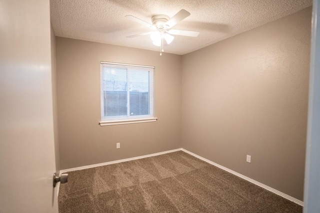 spare room with a textured ceiling, carpet floors, and ceiling fan