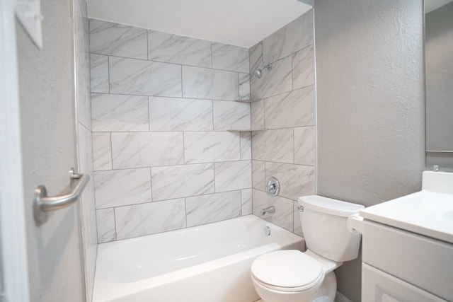 full bathroom featuring tiled shower / bath combo, vanity, and toilet