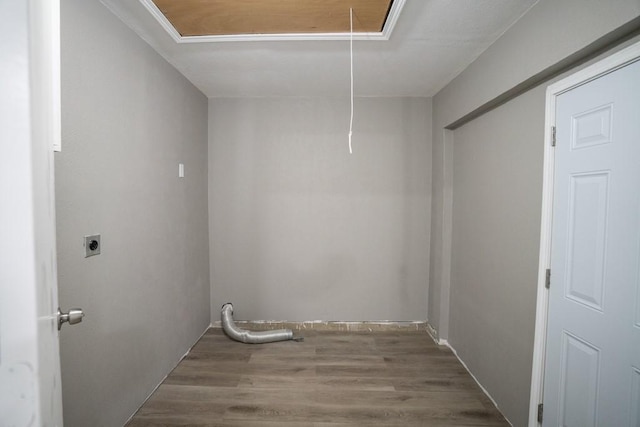 washroom with crown molding, electric dryer hookup, and hardwood / wood-style floors