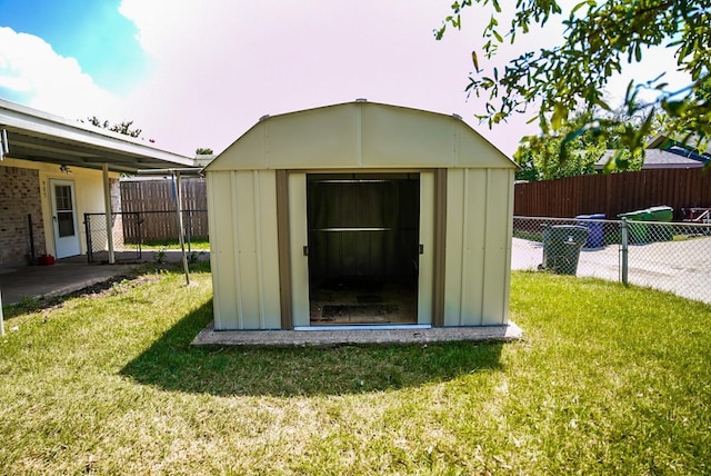 view of outbuilding with a yard