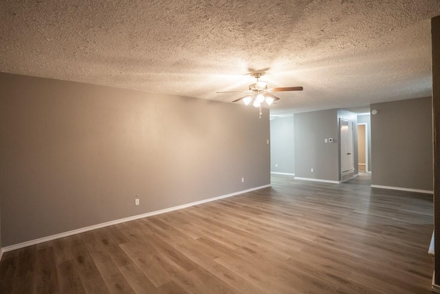 spare room featuring ceiling fan, hardwood / wood-style floors, and a textured ceiling