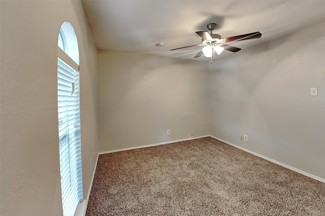 spare room with ceiling fan and carpet flooring