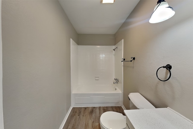 bathroom with bathing tub / shower combination, hardwood / wood-style floors, and toilet