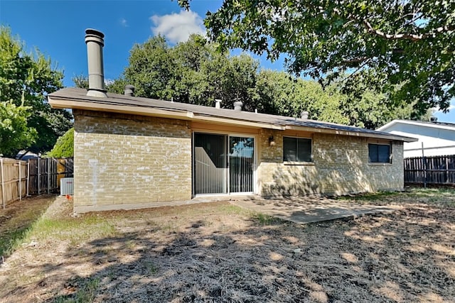 back of house featuring central AC unit