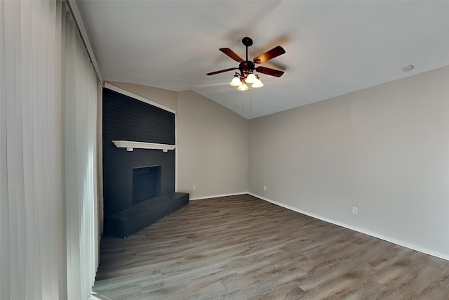 unfurnished living room featuring a large fireplace, ceiling fan, and light wood-type flooring