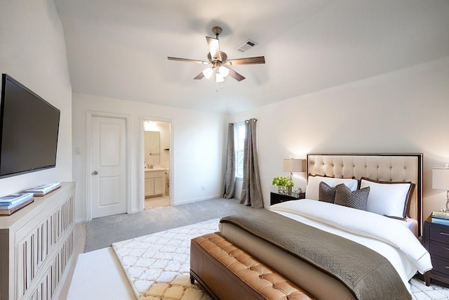 carpeted bedroom featuring ceiling fan and ensuite bath