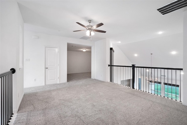 spare room featuring ceiling fan and carpet flooring