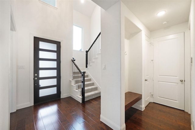 entryway with dark hardwood / wood-style flooring