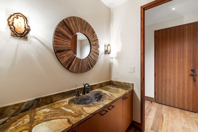 bathroom featuring hardwood / wood-style flooring and vanity