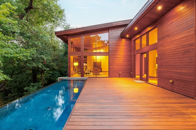 pool at dusk with a deck