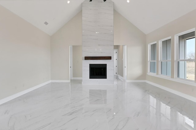 unfurnished living room with a large fireplace and high vaulted ceiling