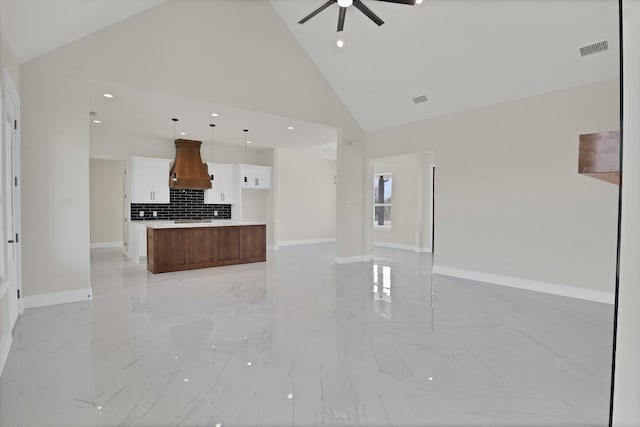 unfurnished living room with sink, high vaulted ceiling, and ceiling fan