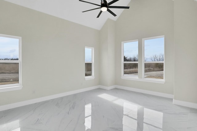 unfurnished room with ceiling fan and high vaulted ceiling