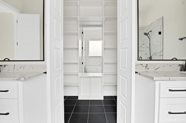 bathroom featuring vanity, a shower, and tile patterned floors