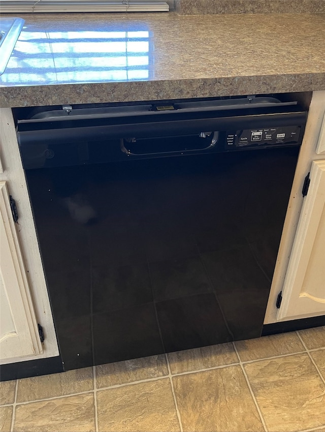 details with white cabinetry and black dishwasher