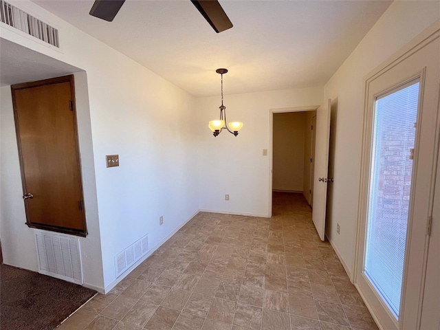 unfurnished room with ceiling fan with notable chandelier