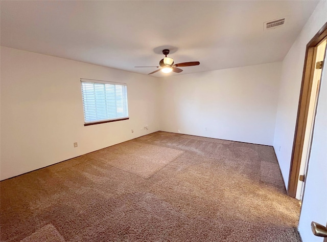 spare room featuring carpet floors and ceiling fan