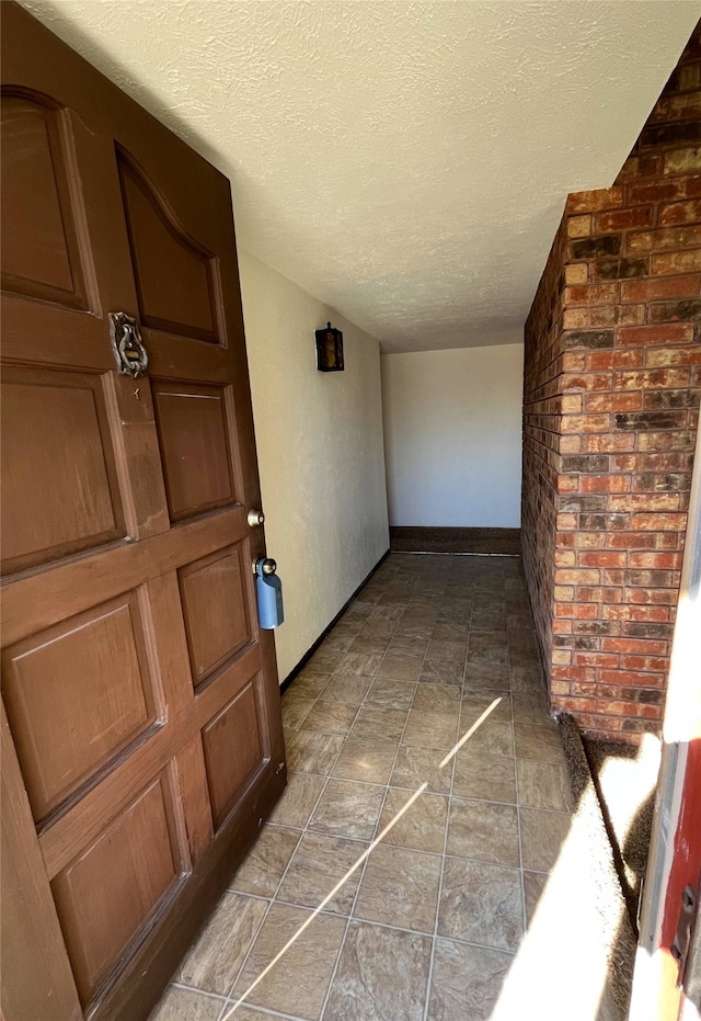 hallway with a textured ceiling